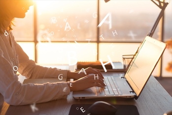 Female hands on keyboard texting using laptop and internet, working online. Freelancer typing at office, workplace.