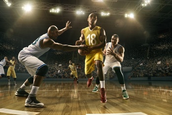 Basketball players on big professional arena during the game