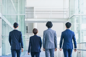 オフィスの廊下を歩くビジネスマンの男女