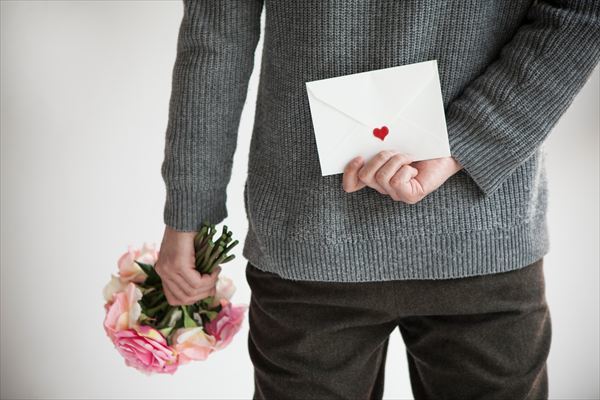 Men hide cute bouquets and letters behind