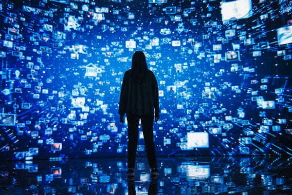 Young Woman Standing Before a Dynamic Digital Screen